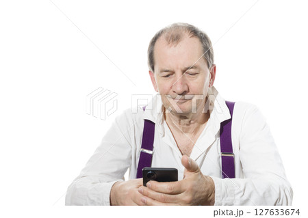 Portrait of a sixty-year-old man in a white shirt. 127633674