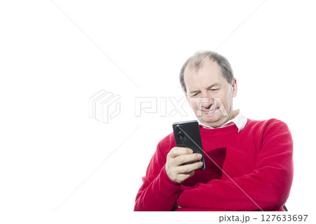 Portrait of a sixty-year-old man in a red pullover. 127633697