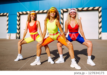 Young dancers in colorful swimsuits are dancing in morning. ?oncept of sports, fitness Active sport. Young dancers in colorful swimsuits are dancing in morning. ?oncept of sports, fitness Active sport. 127634173