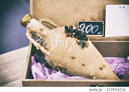 Antique ceramic bottle amphora with wine 127634216