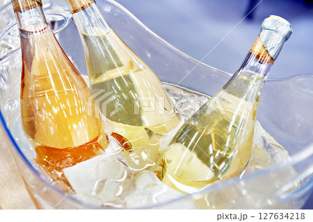 Champagne bottles in ice water 127634218