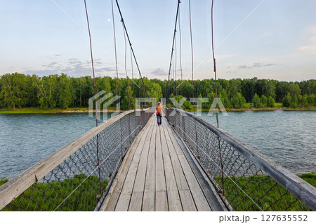 wooden footbridge with rails over Koksa river 127635552