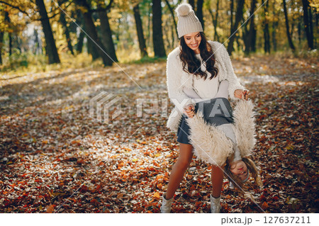 Beautiful mother with daughter. Family in a autumn park. Golden autumn 127637211