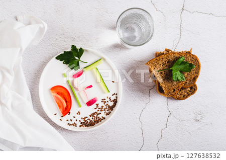 Concept diet on a plate of low-calorie foods on the table top view 127638532