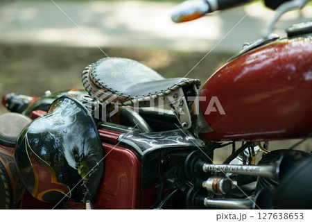 Red Bobber Motorcycle Detail with Leather Seat Red Bobber Motorcycle Detail with Leather Seat 127638653