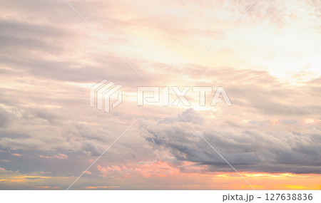 Dramatic overcast sky panorama with gray storm clouds during golden hour sunset creating moody atmospheric background for climate change awareness campaigns and emotional weather storytelling content 127638836