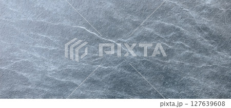 Travertine leathered stone with fine natural white veins and cool gray tones 127639608