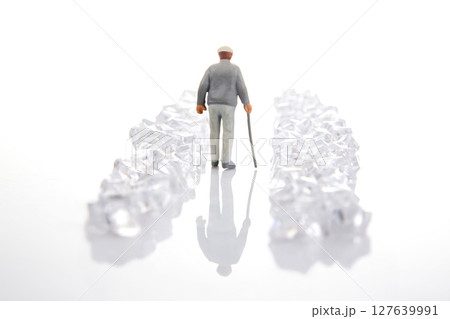 miniature figure in a gray suit walks through a dazzling crystal-lined path on a reflective surface, miniature figure in a gray suit walks through a dazzling crystal-lined path on a reflective surface, 127639991