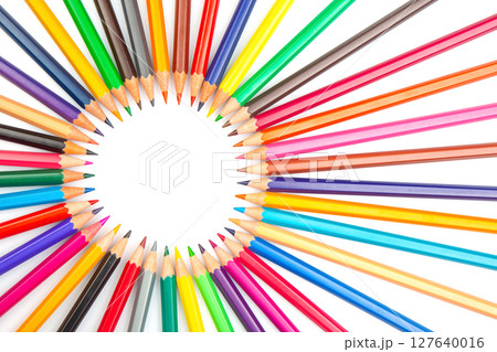 A circular array of sharpened colored pencils in various hues, set against a white background A circular array of sharpened colored pencils in various hues, set against a white background 127640016