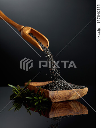 Black sesame on a black reflective background. Black sesame on a black reflective background. 127640536
