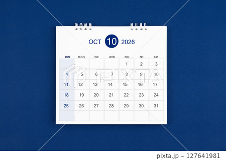 October 2026 Monthly desk calendar on navy blue color leather background. 127641981