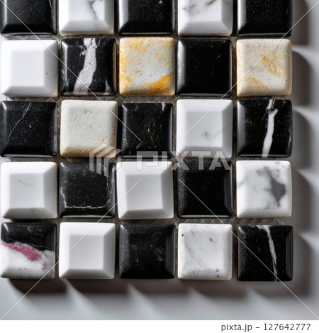 Glossy black and white ceramic tiles with veining and subtle golden marble accents Glossy black and white ceramic tiles with veining and subtle golden marble accents 127642777