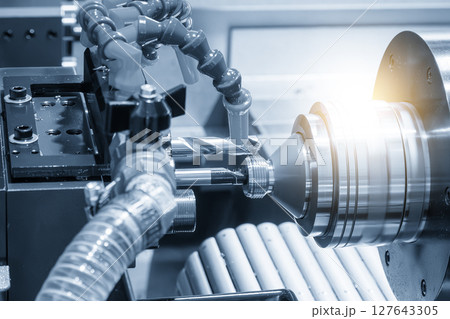 The multi tasking CNC lathe machine Swiss type bore cutting process the metal tube parts in the light blue scene. The multi tasking CNC lathe machine Swiss type bore cutting process the metal tube parts in the light blue scene. 127643305