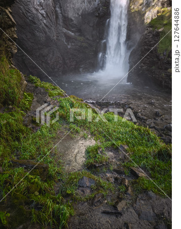 Powerful waterfall plunging through lush greenery into rocky pool, capturing autumnal landscape near aosta, italian alps in november Isollaz waterfall Powerful waterfall plunging through lush greenery into rocky pool, capturing autumnal landscape near aosta, italian alps in november Isollaz waterfall 127644886