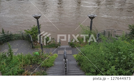 Flooded vltava river engulfing prague embankment after heavy rainfall 127644973
