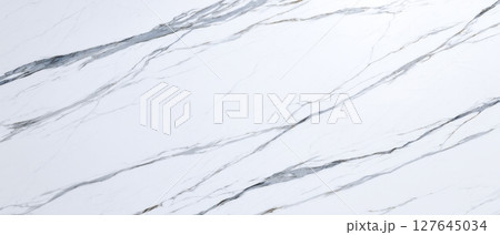 Statuario white marble slab with soft grey veining, high-resolution closeup of elegant natural stone texture for luxury interior background and modern wall surface design Statuario white marble slab with soft grey veining, high-resolution closeup of elegant natural stone texture for luxury interior background and modern wall surface design 127645034