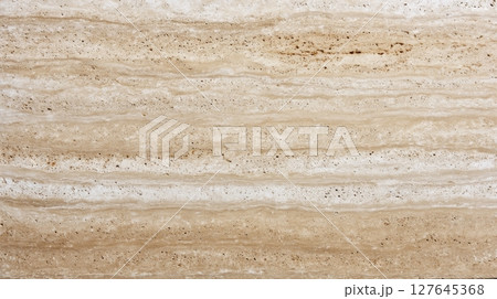 Natural travertine stone with light creamy beige layers in macro flatlay view 127645368