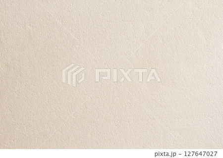 Close-up of light beige foam texture with subtle hexagonal pattern and soft lighting across surface. Concept of texture, minimal design, neutral background 127647027