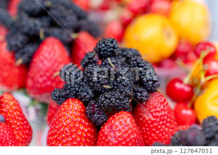 Assorted containers of berries for sale at a market. Fruits Assorted containers of berries for sale at a market. Fruits 127647051
