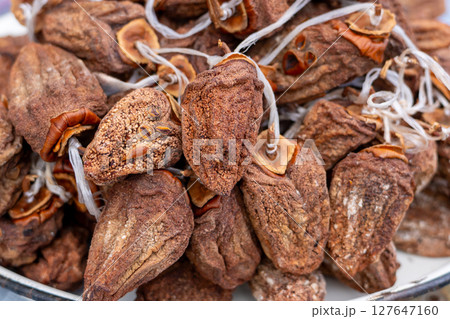 Dried persimmon fruits are sold at the market. Fruits Dried persimmon fruits are sold at the market. Fruits 127647160