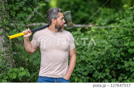 Brutality and masculinity. Hispanic lumberjack man with axe. Lumberjack axe. Man with logging axe. Hardworking brutal man. Lumberjack hardworking outdoor. Brutal lumberjack, copy space 127647557