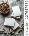Blank business cards on concrete surface with decorative elements 127647639