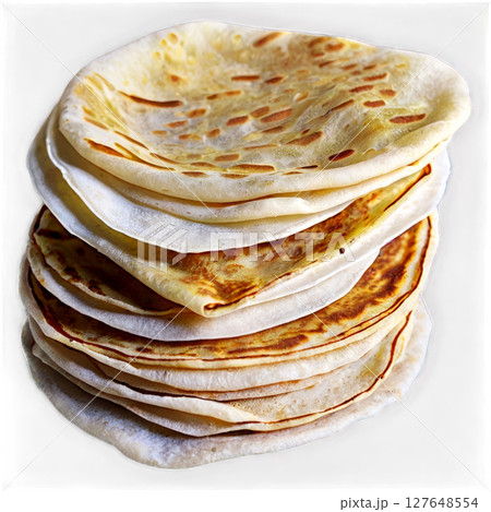 Soft and golden flatbreads stacked on a white surface, ready for serving at a meal Soft and golden flatbreads stacked on a white surface, ready for serving at a meal 127648554