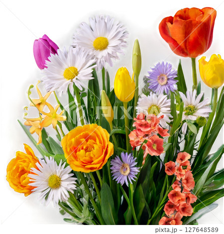 A vibrant bouquet of assorted flowers in a clear vase brightens the room in springtime 127648589