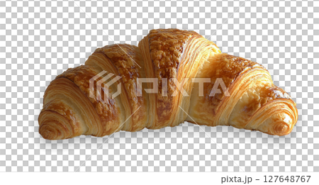 Freshly baked buttery croissant resting on a smooth surface in morning light 127648767