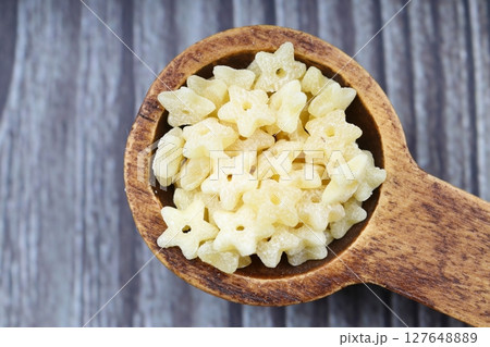Raw Organic Stelline Pasta in a Bowl, top view. Flat lay, overhead, from above. Macaroni stars. Star shaped noodles. 127648889