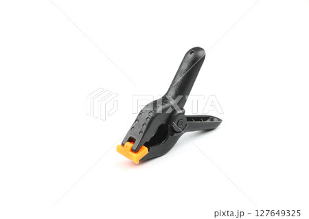 black plastic spring clamp isolated over white background 127649325