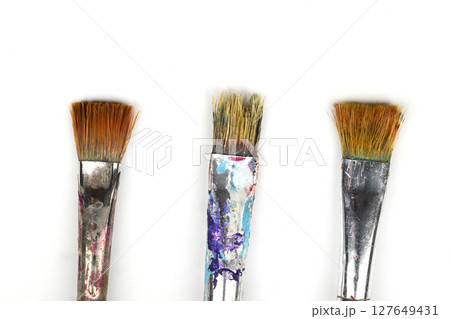 Artistic brushes close up. Watercolor paints in the background. Background with brushes and paints. 127649431