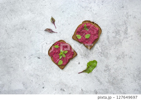 Beetroot Spread Generously Served on Grain Toast with Fresh Herbs 127649697
