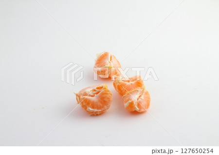 Ripe mandarin with leaves close-up on a white background. Tangerine orange with leaves on a white 127650254