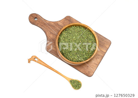 Dry mint in wooden bowl isolated on white background Dry mint in wooden bowl isolated on white background 127650329