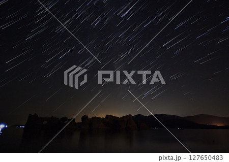 A view of the stars of the Milky Way with a mountain top in the foreground.Perseid Meteor Shower observation 127650483