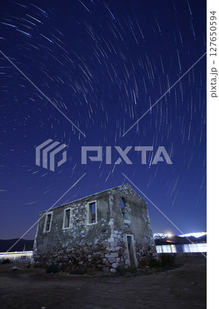 A view of the stars of the Milky Way with a mountain top in the foreground.Perseid Meteor Shower observation 127650594