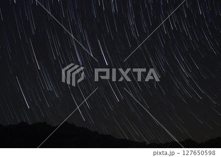 A view of the stars of the Milky Way with a mountain top in the foreground.Perseid Meteor Shower observation 127650598