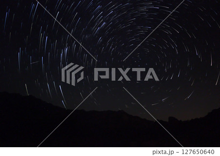 A view of the stars of the Milky Way with a mountain top in the foreground.Perseid Meteor Shower observation 127650640