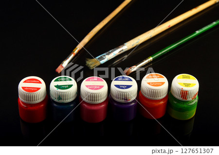 Artistic brushes close up. Watercolor paints in the background. Background with brushes and paints. 127651307