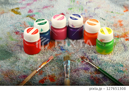 Artistic brushes close up. Watercolor paints in the background. Background with brushes and paints. 127651308