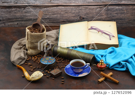 Turkish coffee concept. Copper pot (Cezve), vintage coffee grinder, coffee beans on a dark wooden background. Arab Turkish east coffee top view on dark wood background 127652096