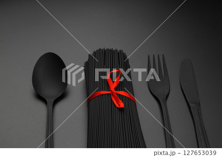 Raw black homemade spaghetti bunch isolated. Dry black noodles macaroni bundle. Close-up Raw black homemade spaghetti bunch isolated. Dry black noodles macaroni bundle. Close-up 127653039