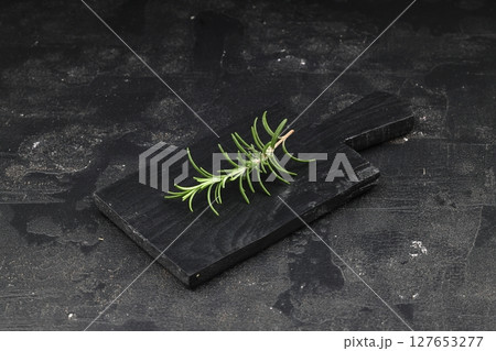 Dry organic background or texture of rosemary leaves. Healthy food concept . a wooden spoon with rosemary, a kind of green color and very fine sticks. leaning on a brown table. Dry organic background or texture of rosemary leaves. Healthy food concept . a wooden spoon with rosemary, a kind of green color and very fine sticks. leaning on a brown table. 127653277