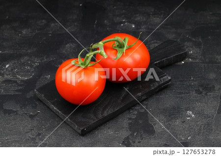 Fresh cherry tomatoes on a black background. Bunch of fresh cherry tomato on a black background 127653278