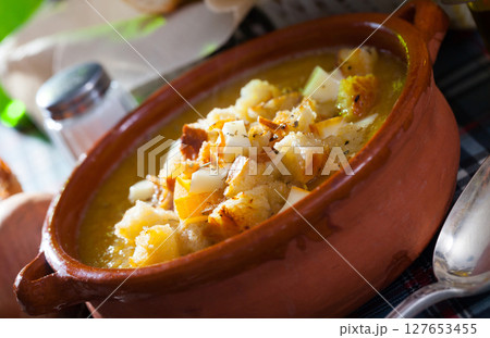 Cream soup with croutons and cheese Cream soup with croutons and cheese 127653455