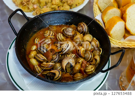 Grape snails in sauce. Spanish dish 127653488