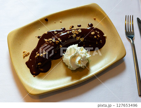 Fried plantain with melted chocolate 127653496