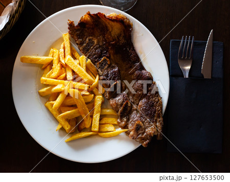 Tasty juicy roasted veal ribs 127653500