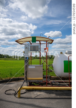 Propane gas station with large storage tank in rural countryside area Propane gas station with large storage tank in rural countryside area 127654599